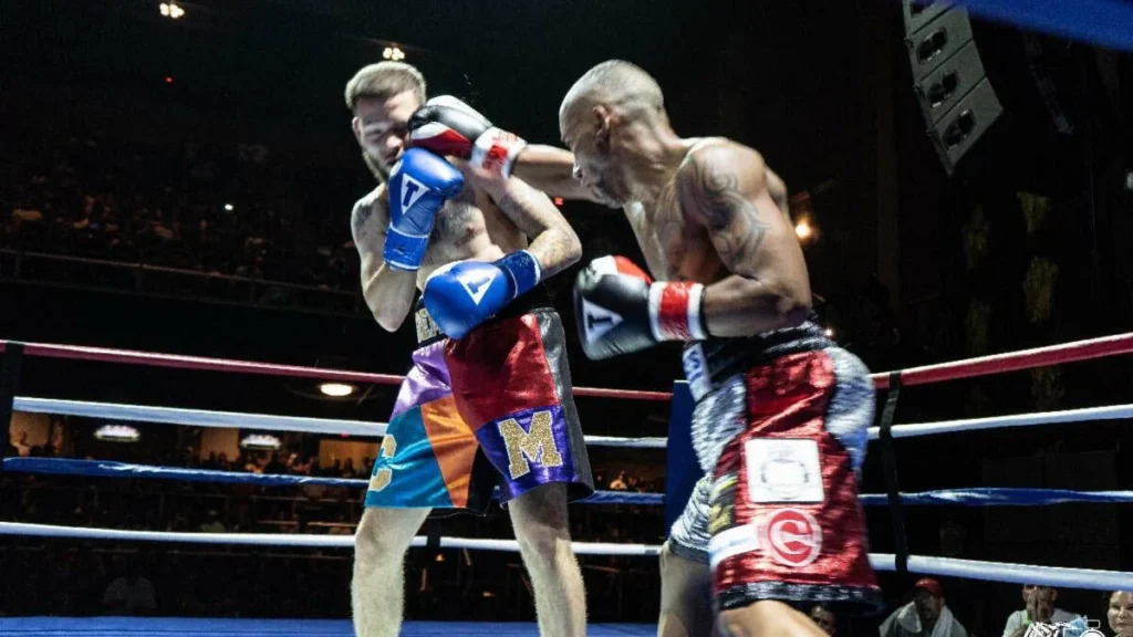 Carlos Marrero III and Wilfredo Pagan exchange punches in a boxing ring.